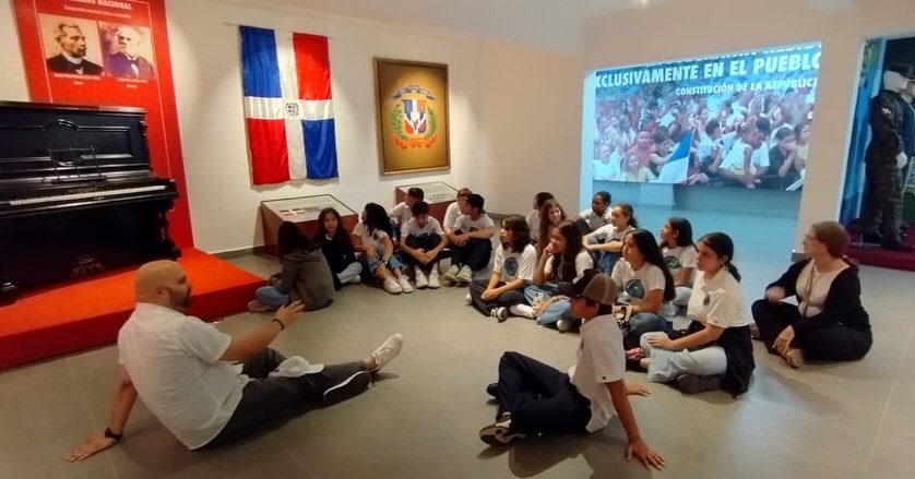 group of students sitting with teacher